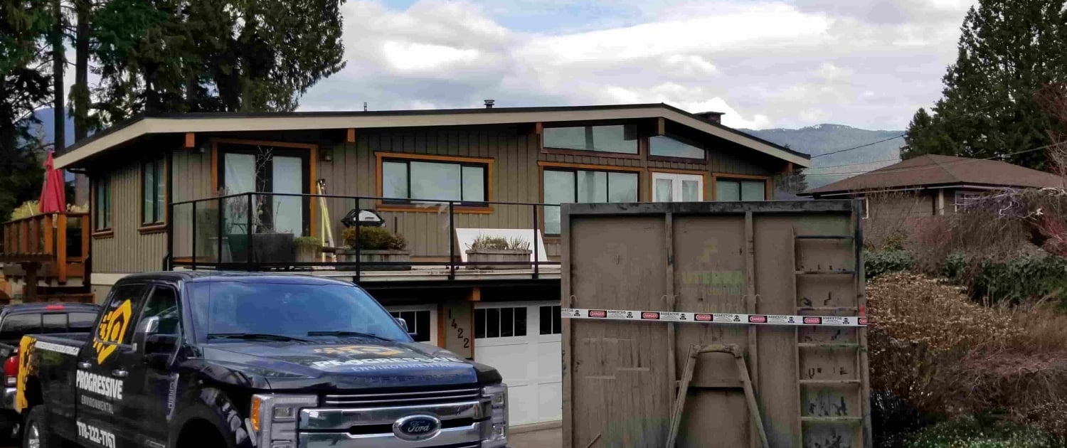 Progressive Asbestos Solutions truck parked in front of Lynn Valley home for asbestos abatement project.